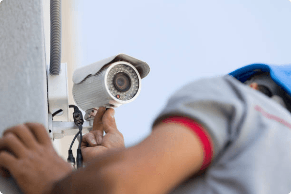 an engineer installing a security camera